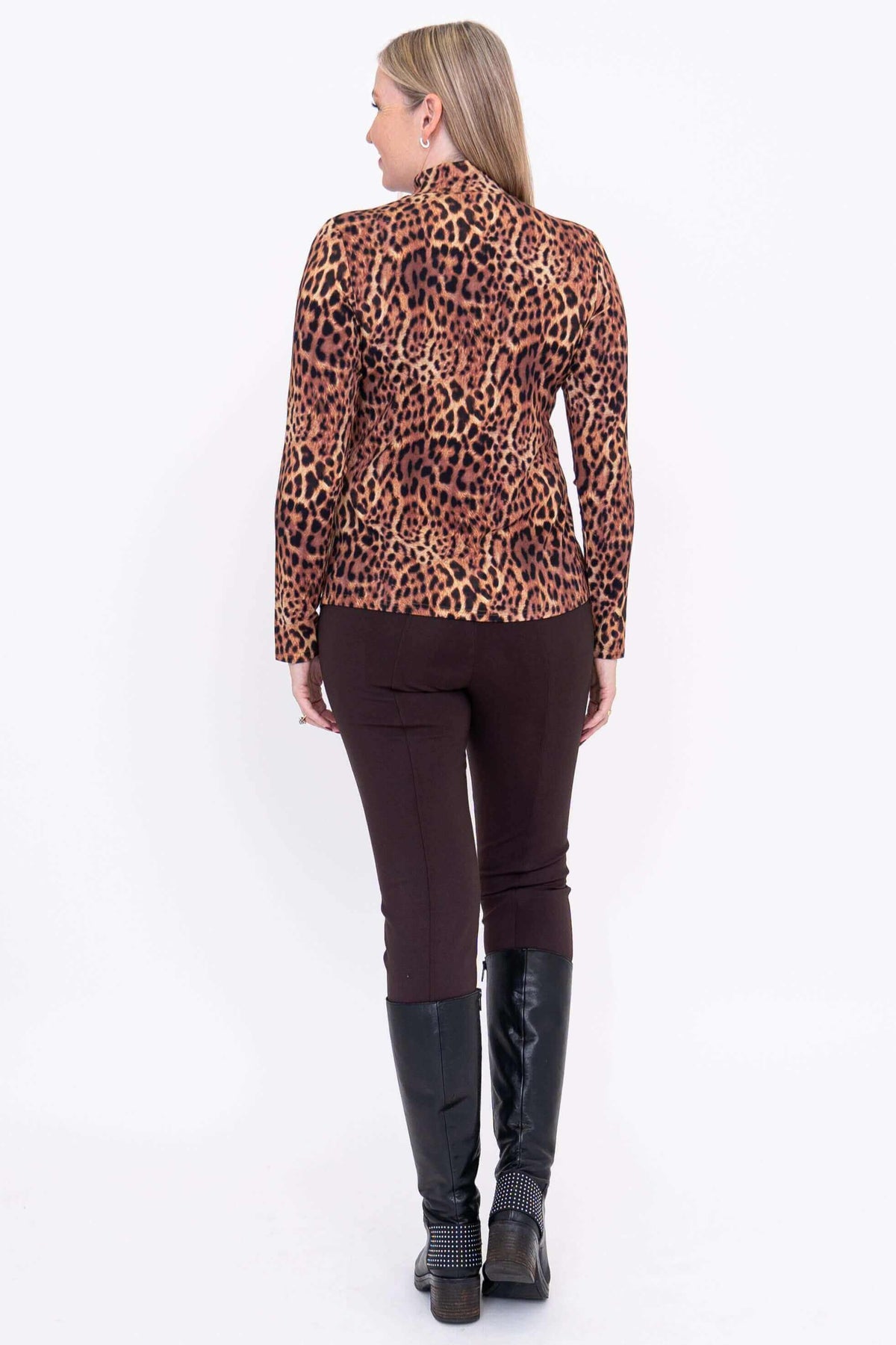 Back view of woman wearing leopard print mock neck long sleeve top and brown pants