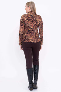 Back view of woman wearing leopard print mock neck long sleeve top and brown pants