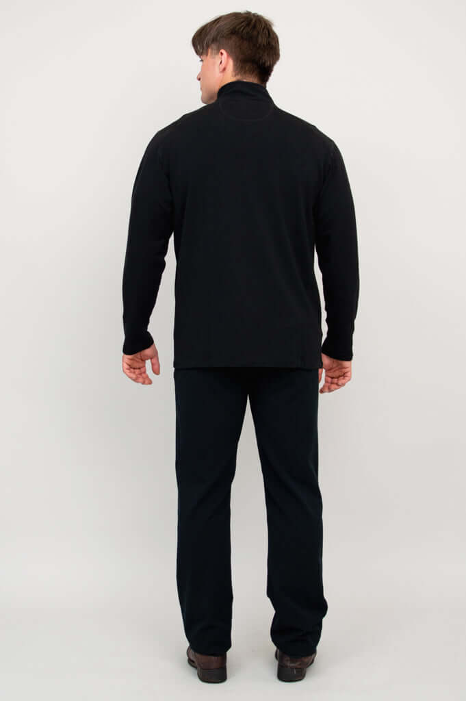 Back view of man in black bamboo fleece zip-up jacket