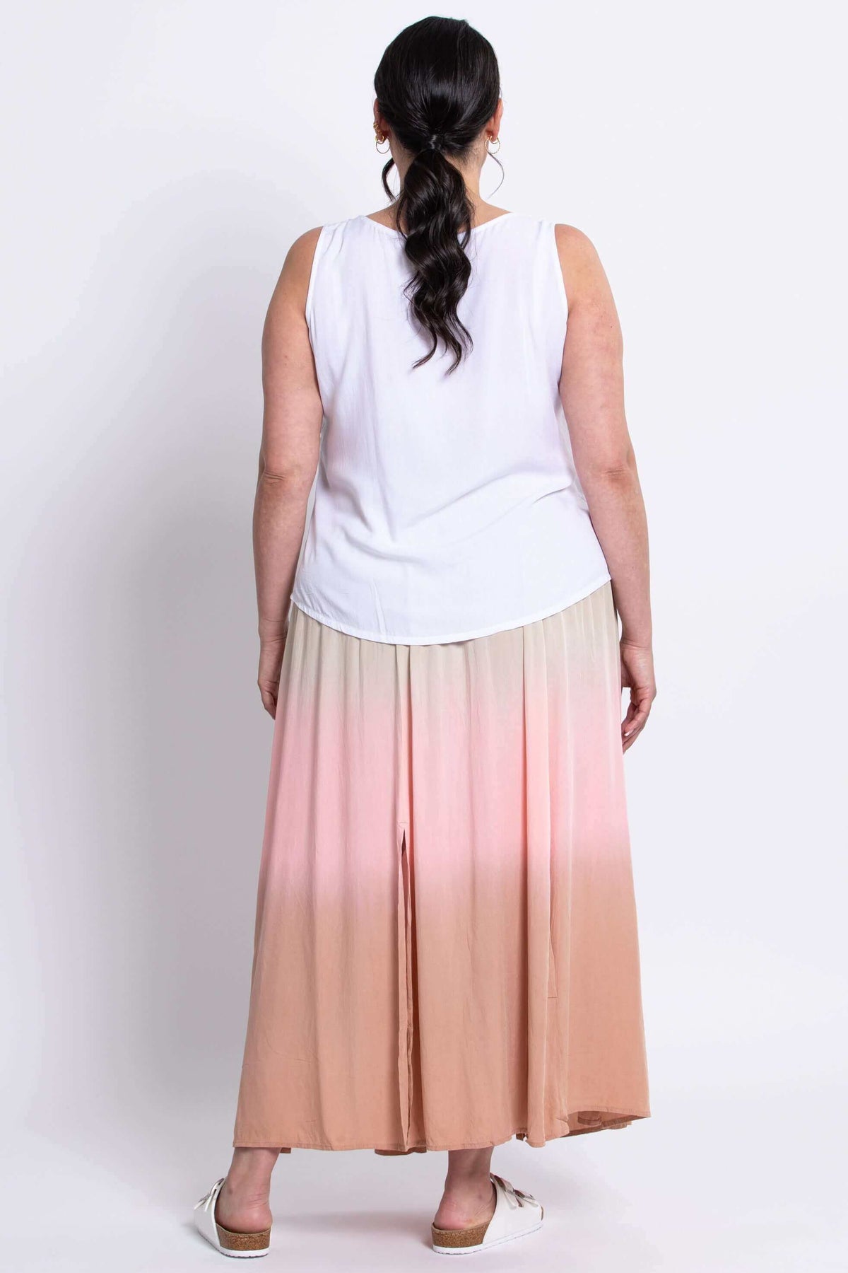 Back view of model in ombre maxi skirt paired with white sleeveless top