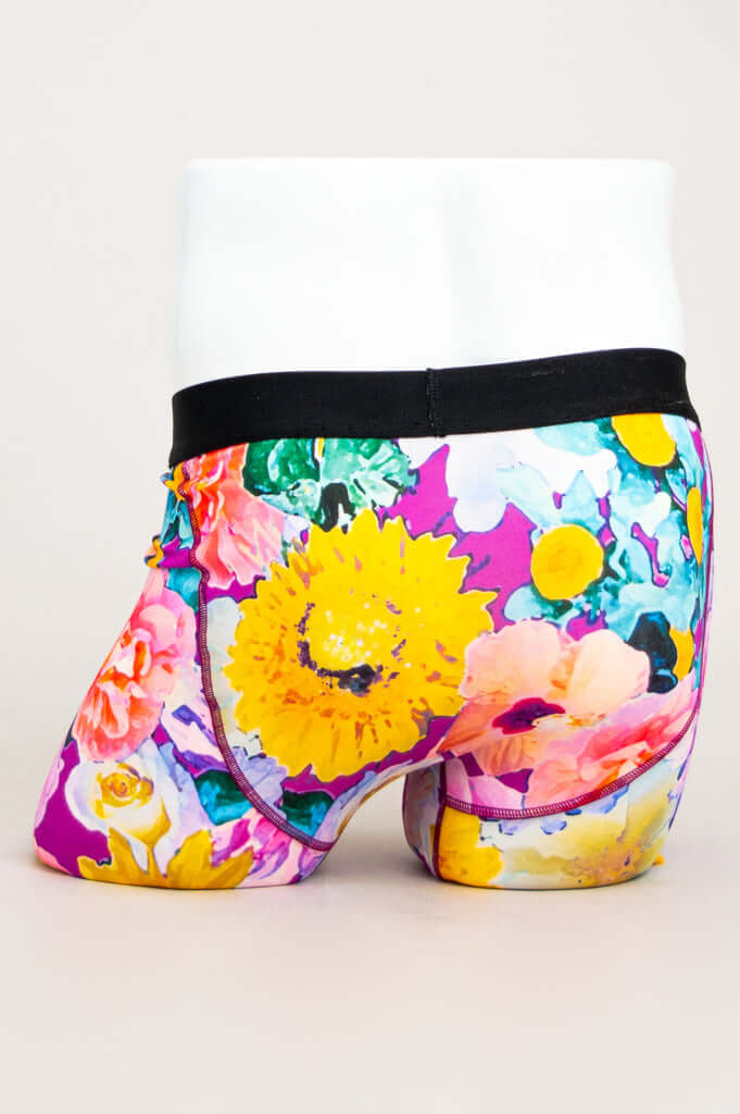 Back view of men's floral bamboo boxer briefs displaying vibrant flower design and black waistband