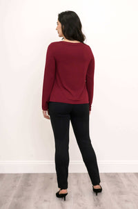 Back view of woman in merlot boat neck top and black pants