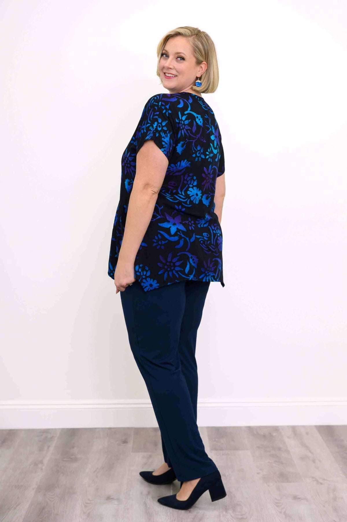 Model showing back view of midnight blossom curved-hem tunic