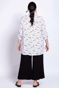 Back view of model wearing the Celine bamboo-linen tunic with black pants
