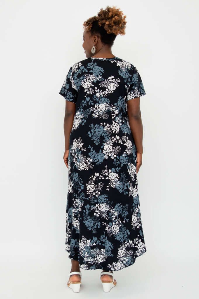 Back view of model in a black floral A-line midi dress