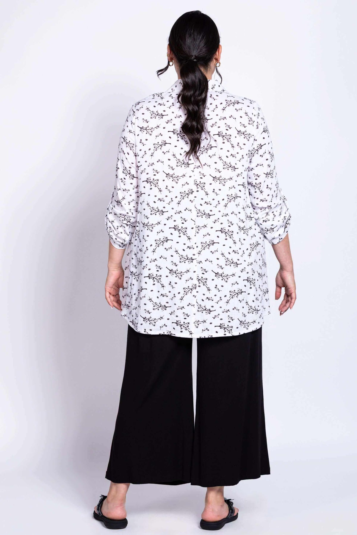 Back view of model showing the flowy fit and print of the tunic top