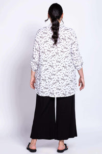 Back view of model showing the flowy fit and print of the tunic top