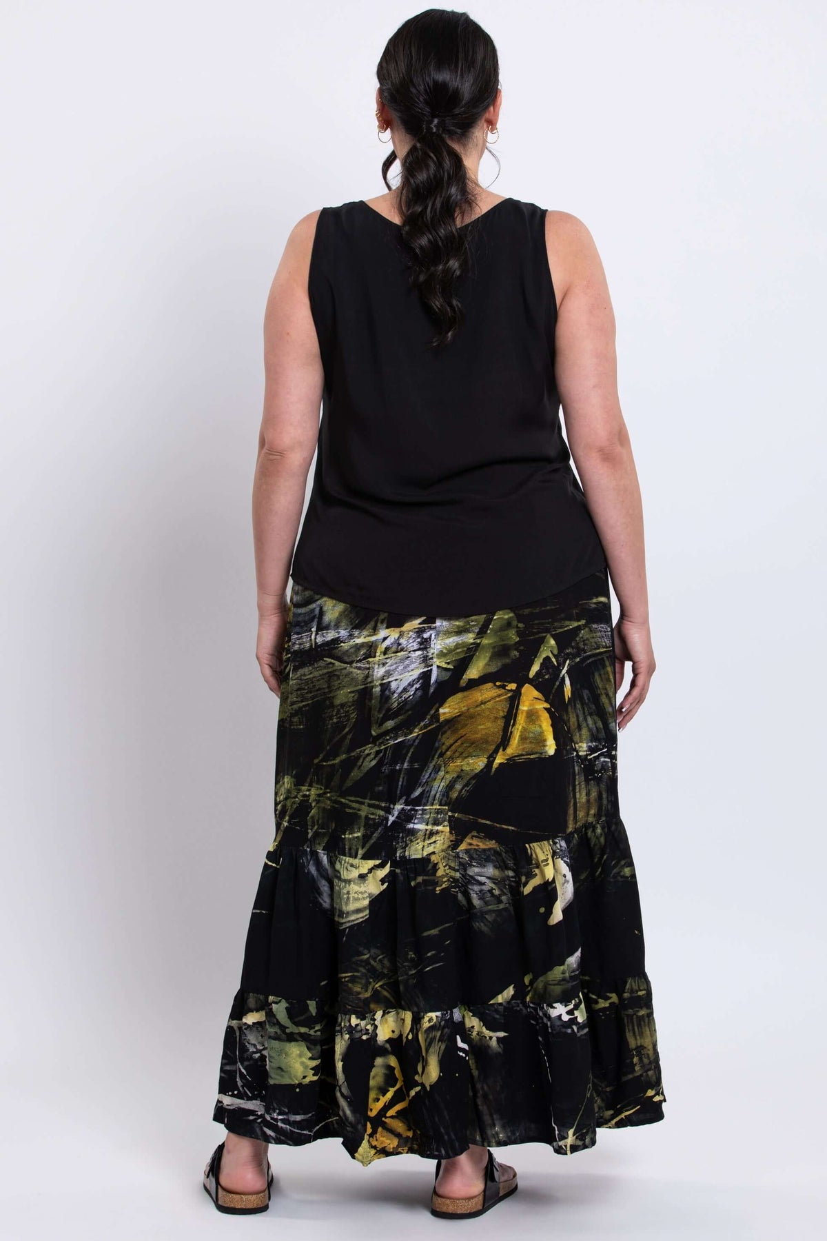 Back view of model wearing Tibby summer skirt, showing three-tier ankle-length detail