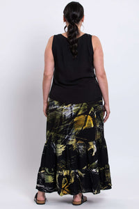 Back view of model wearing Tibby summer skirt, showing three-tier ankle-length detail