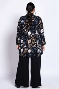 Back view of model wearing black floral batik print tunic shirt