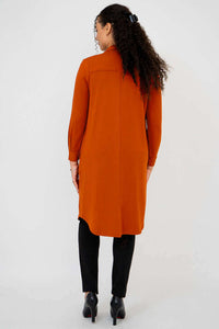 Back view of model wearing rust bamboo duster shirt and black pants