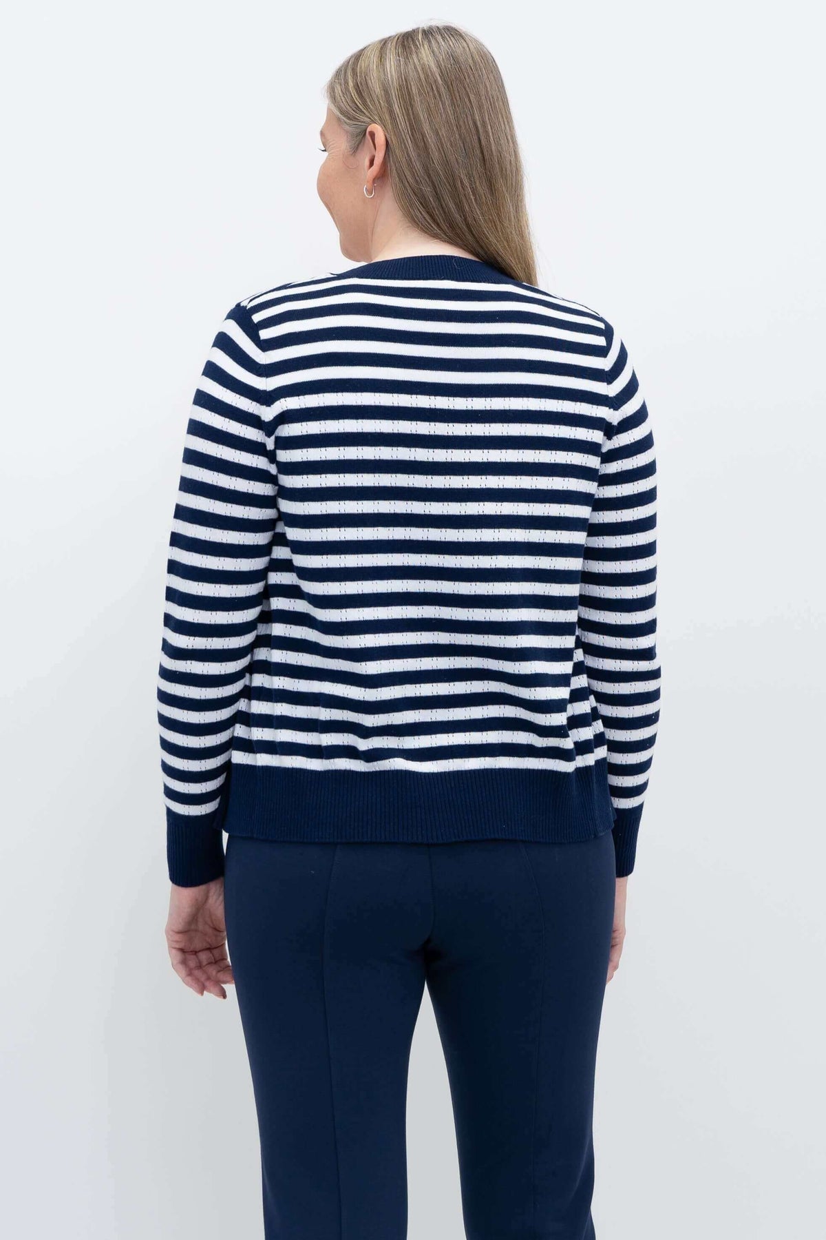 Back view of woman wearing navy and white Breton striped cotton cardigan
