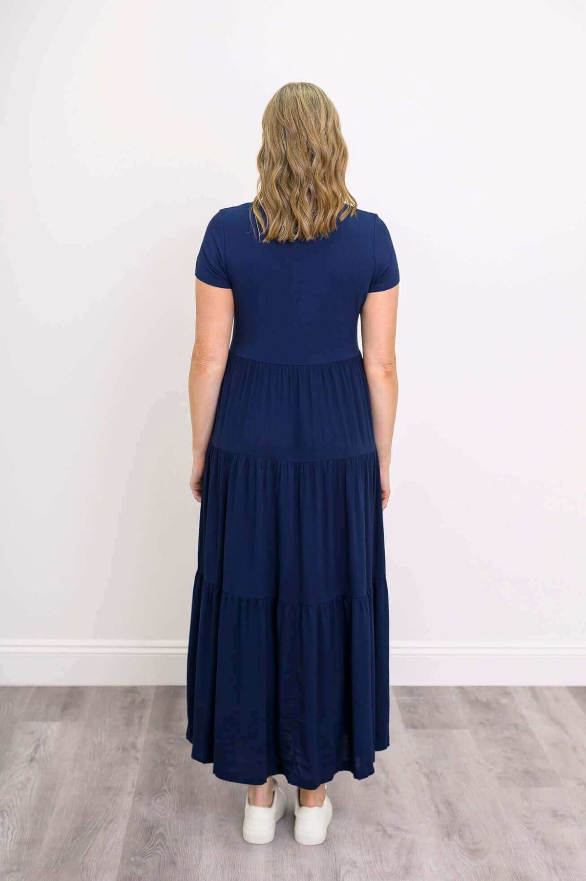 Back view of navy blue tiered maxi dress showing skirt detail