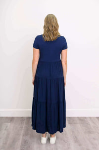 Back view of navy blue tiered maxi dress showing skirt detail