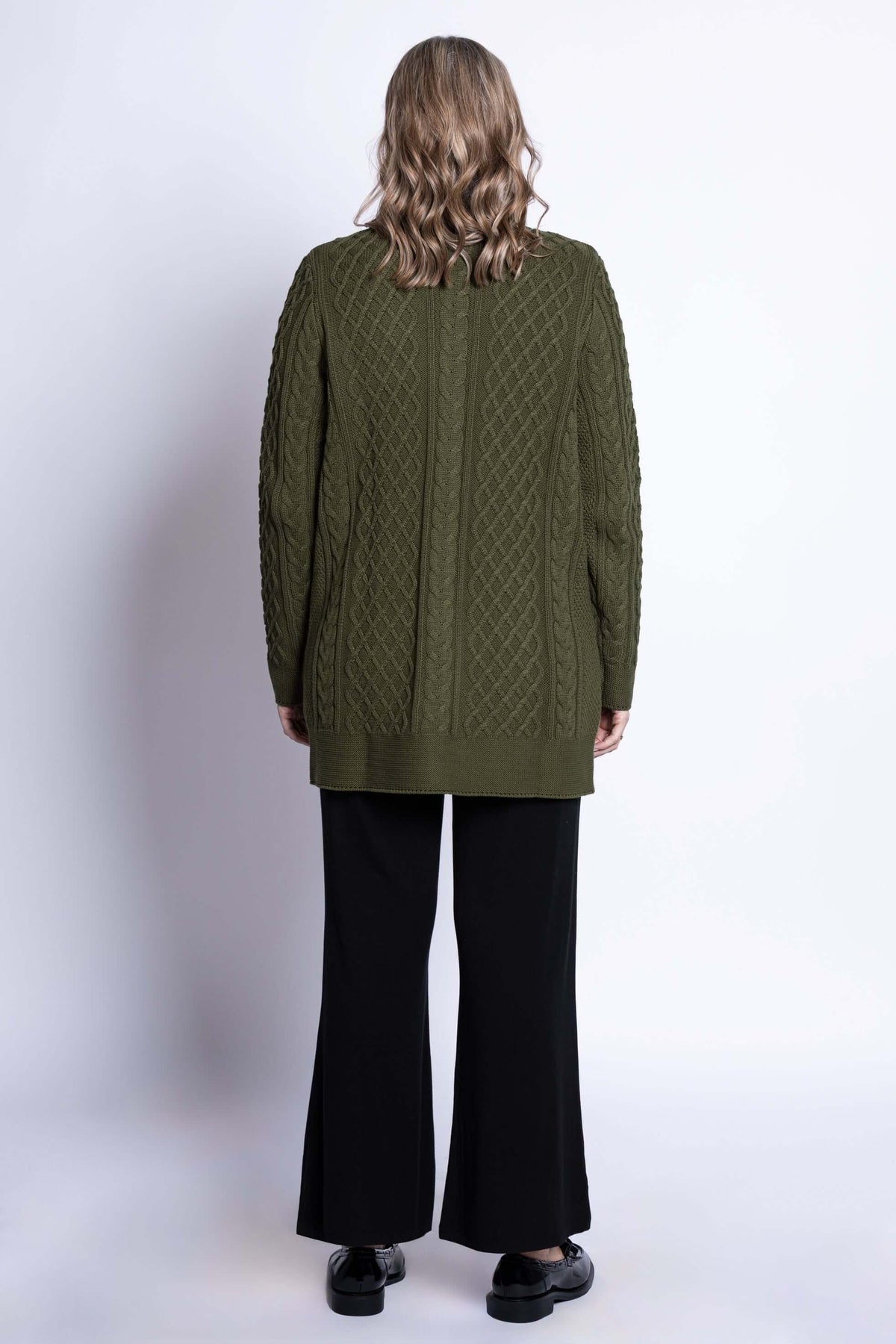 Back view of a woman showcasing the olive green cable knit cardigan's woven pattern