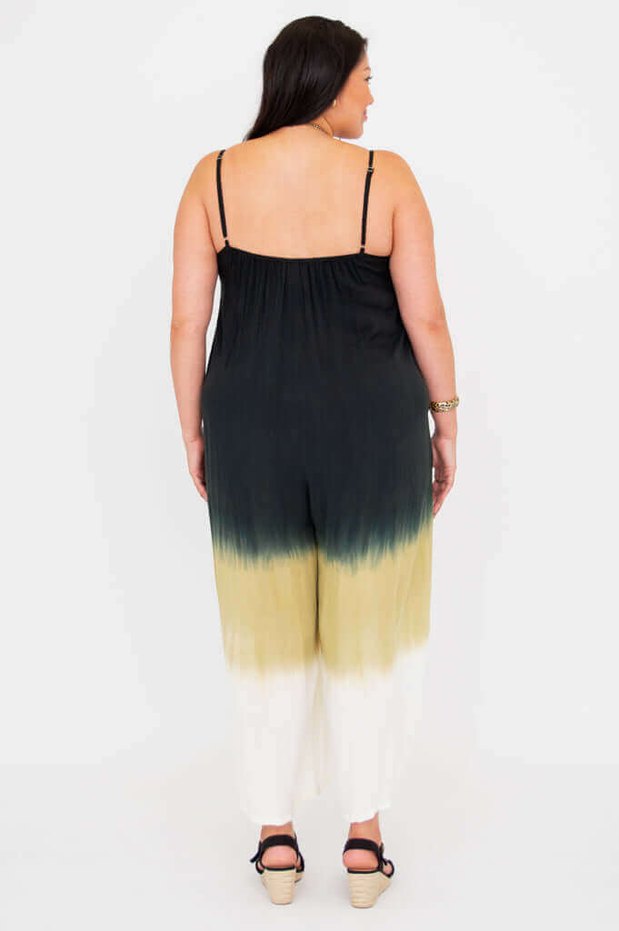Back view of a woman wearing an ombre jumpsuit with spaghetti straps and loose fit