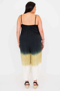 Back view of a woman wearing an ombre jumpsuit with spaghetti straps and loose fit