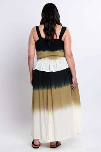 Back view of woman wearing ombre maxi skirt with elastic waistband and flowing fabric