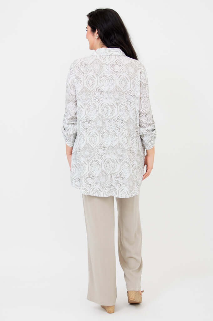 Back view of a woman wearing a patterned oversized bamboo-linen tunic with long dark hair