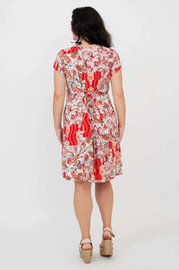 Rear view of woman wearing a paisley red and white dress with corset tie