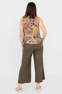 Back view of a woman wearing a bold print Bamboo Linen tank top and wide-leg pants
