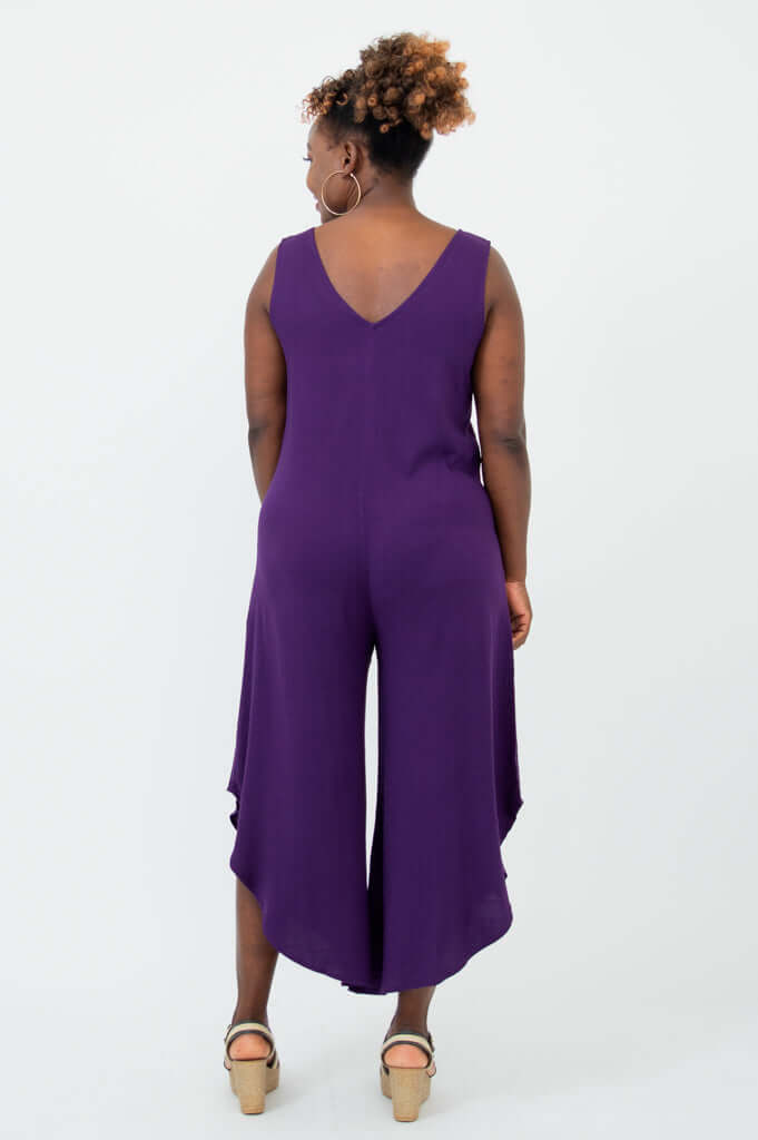 Rear view of model wearing purple jumpsuit showing V-back detail