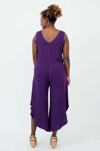 Rear view of model wearing purple jumpsuit showing V-back detail
