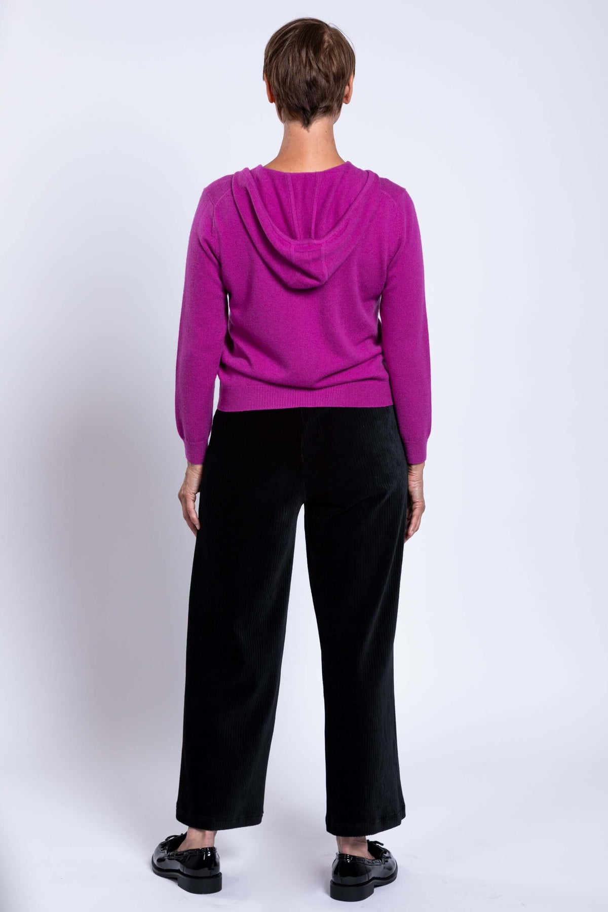 Rear view of a woman showing the hood and fit of a purple cashmere-blend zip hoodie