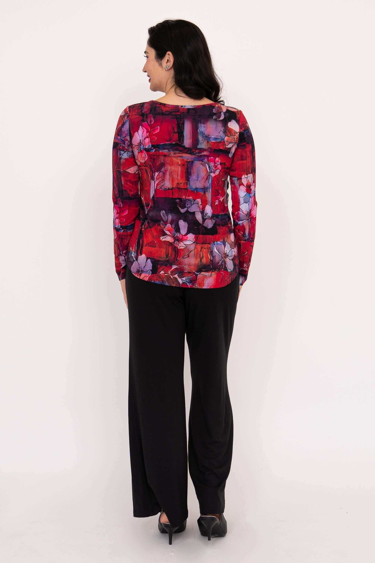 Back view of floral long sleeve top paired with black pants
