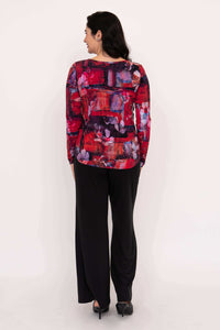 Back view of floral long sleeve top paired with black pants