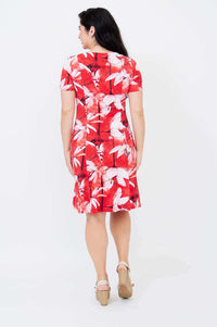 Back view of a woman in a short-sleeved red dress with white floral pattern