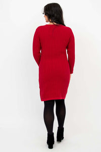Back view of a woman in a red cable knit sweater dress, black tights, and boots