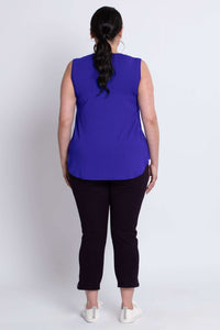 Back view of woman wearing a royal blue bamboo V-neck tank top with black pants.