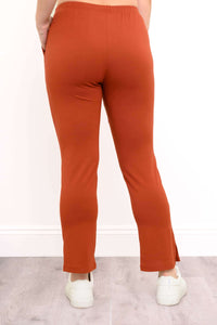 Rear view showing the clean back construction and hemline of women's copper rust French terry pants.