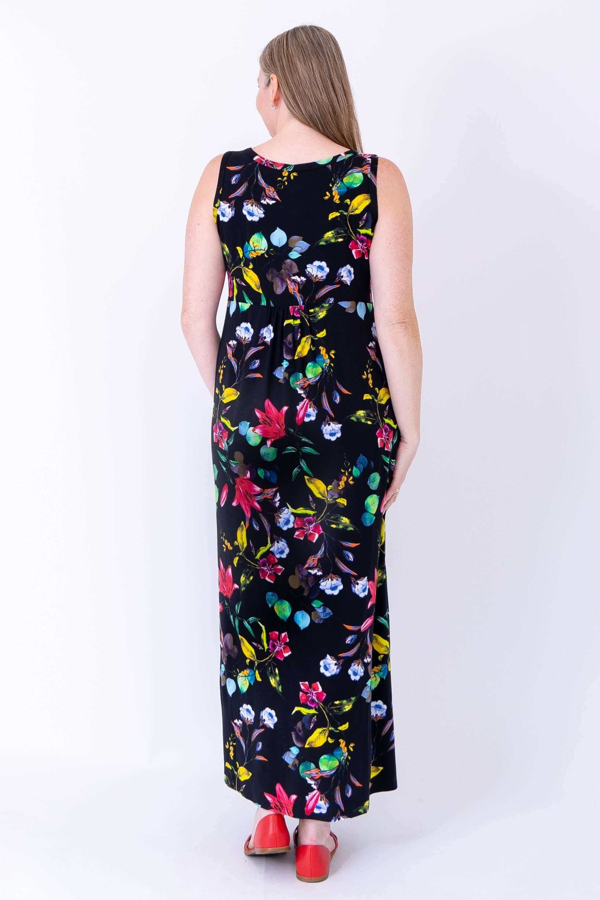 Back view of sleeveless black floral maxi dress, showing details of print and fit