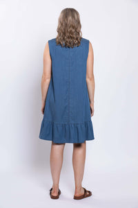 Back view of a woman wearing a sleeveless blue dress with ruffle hem