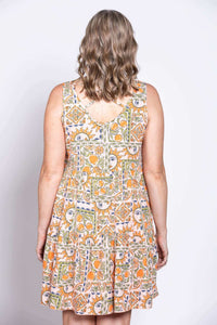Back view of sleeveless dress with criss cross detail and vibrant orange-green print