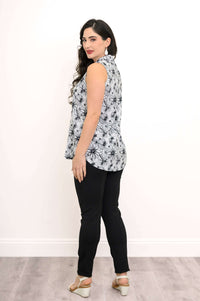 Back view of sleeveless floral zip tank top with black pants