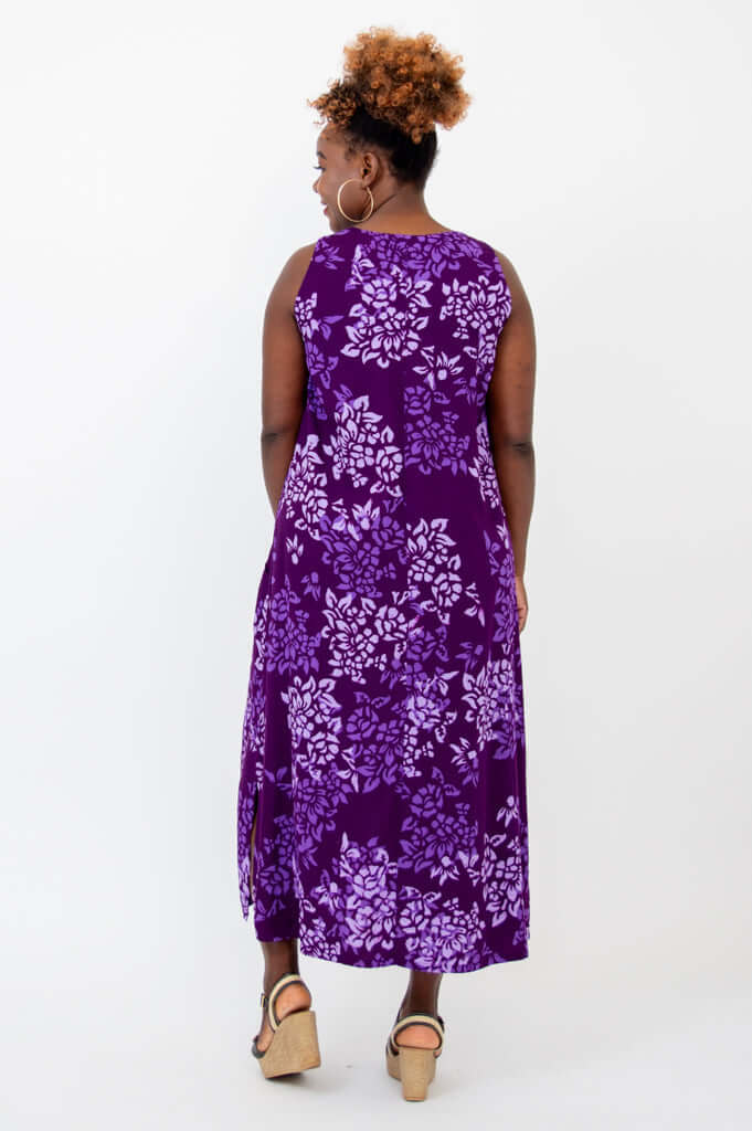 Back view of a model in a purple floral sleeveless maxi dress