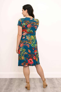 Back view of a woman in a teal floral bamboo wrap dress with short sleeves