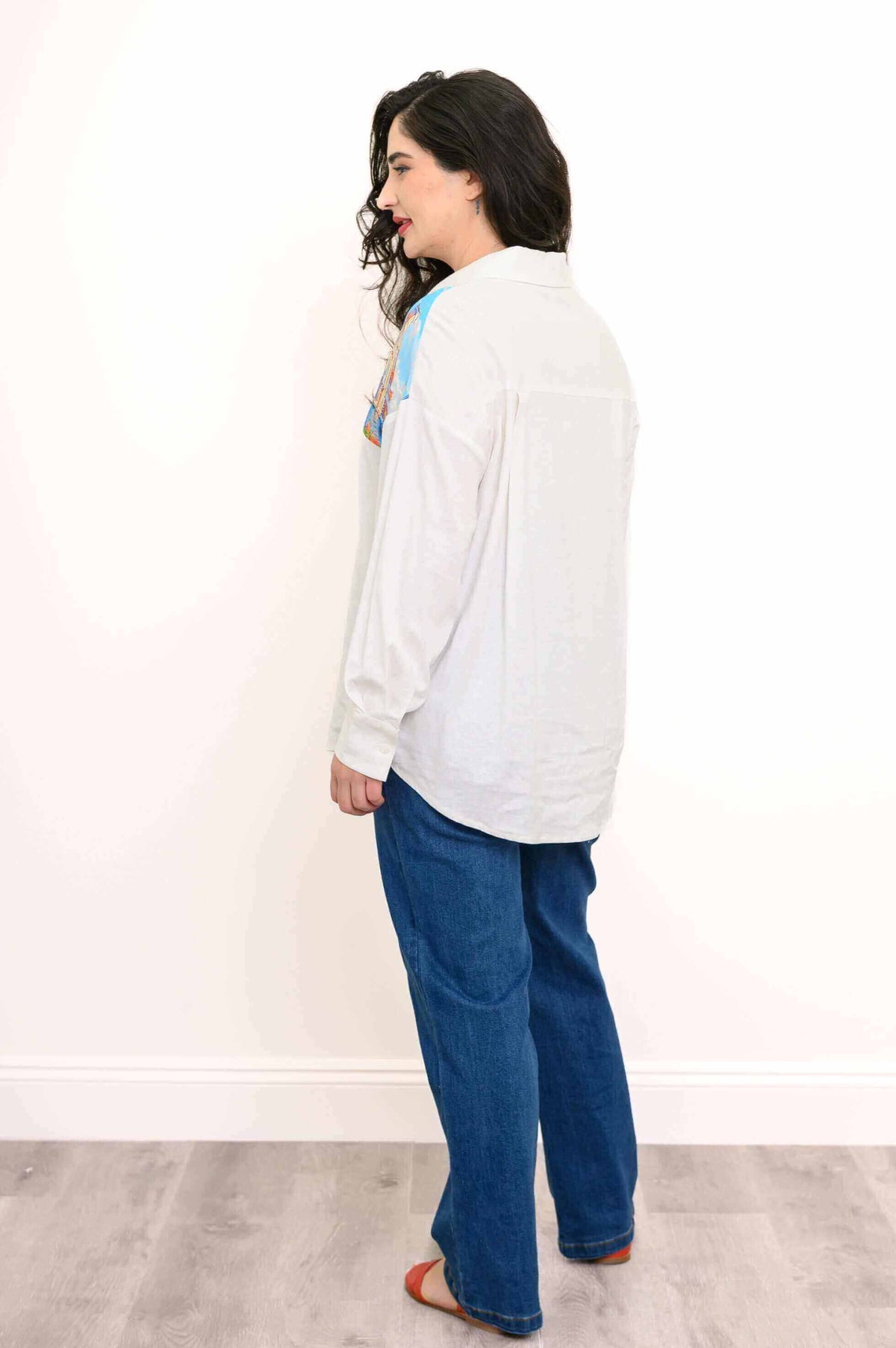 Back view of Alex Blouse on model, emphasizing relaxed cut and pleated back design