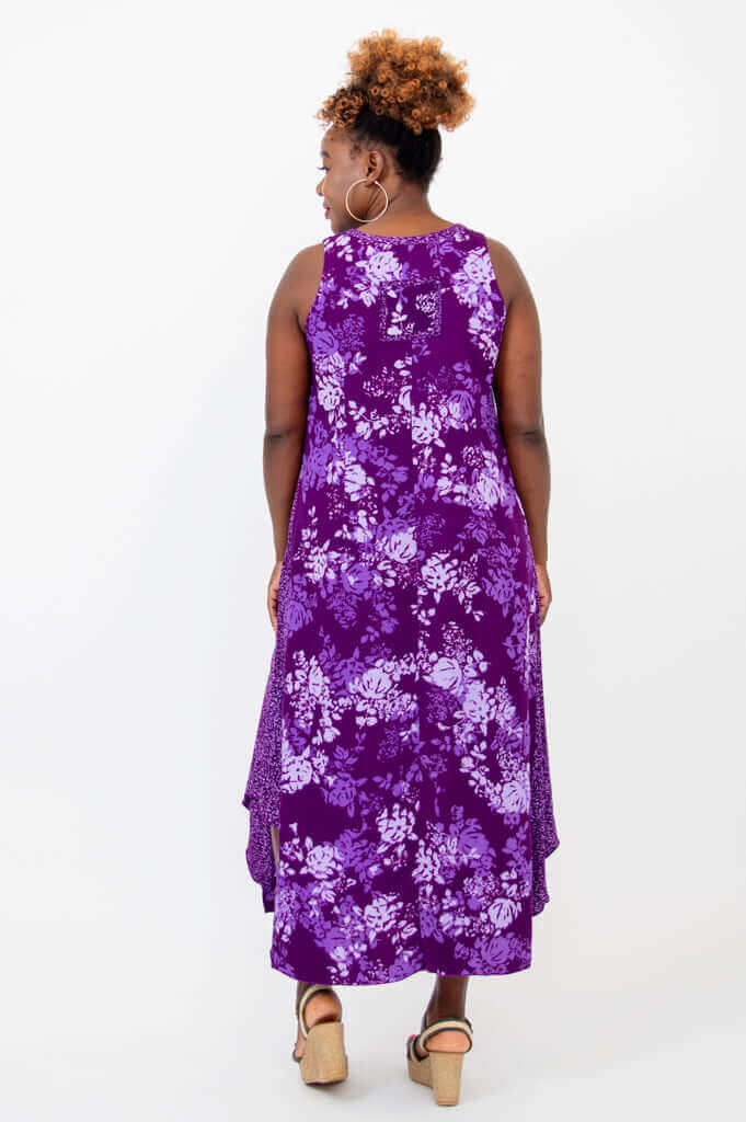 Back view of woman in sleeveless purple floral midi dress