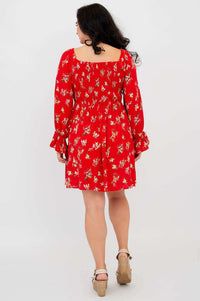 Back view of woman wearing a red ditsy floral dress with square neckline and long sleeves