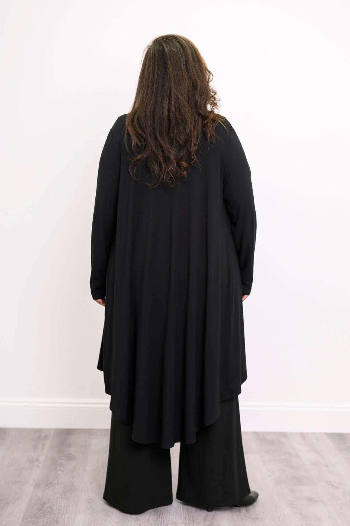 Back view of the black bamboo duster cardigan showing high-low hem detail