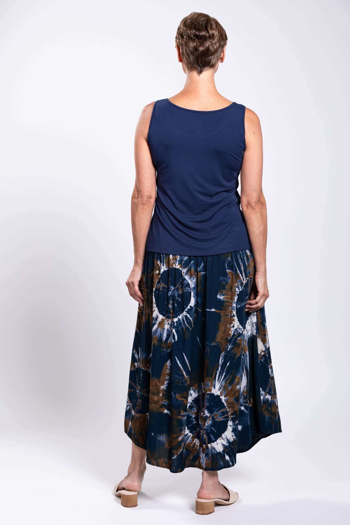 Back view of model wearing the navy and brown tie dye batik midi skirt