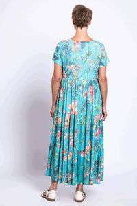 Back view of woman in turquoise floral maxi dress with short sleeves