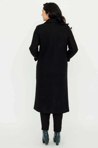 Back view of woman in a long black tailored coat showing seam detail