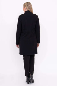Back view of woman in black coat showing gathered waist detail