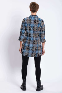 Back view of woman wearing blue and brown plaid long tunic with tabbed sleeves