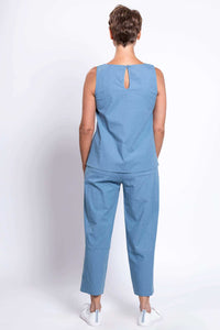 Woman showing back view of blue cropped pants and sleeveless top outfit